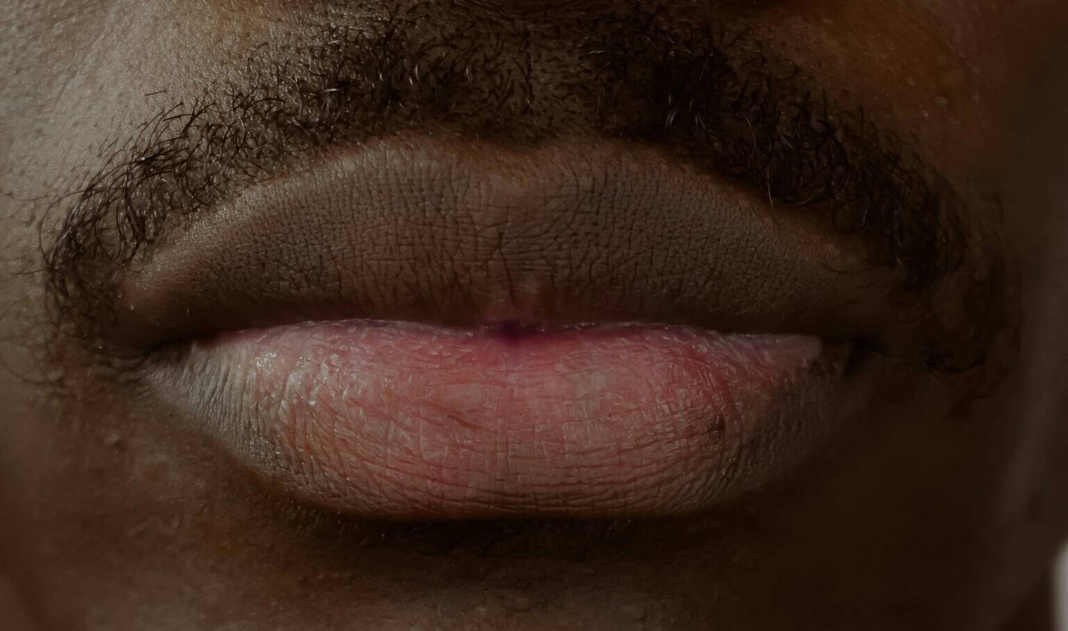 Close up of young man's mouth.